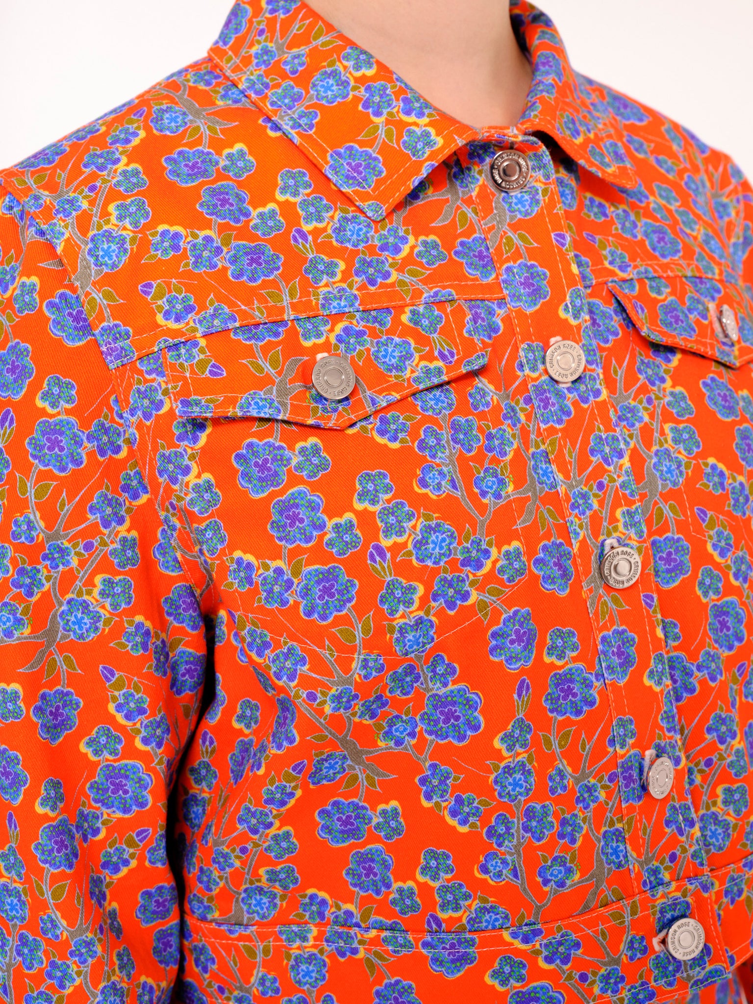 Close up details of the Crimson Rose cropped cotton drill jacket with orange and blue floral print. Photography Rowan Corr.