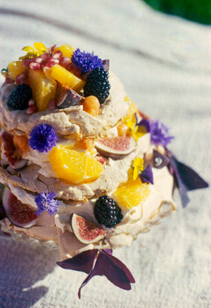 Lemon meringue with an orange sauce and lavender cream decorated with blackberries, figs, oranges, pomegranates, cornflowers and sorrel leaves. Photography 0K Studios.