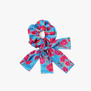 Srunchie with a bow featuring Crimson Rose hand drawn flower print from the Island Dreams collection in blue, red, pink and green.