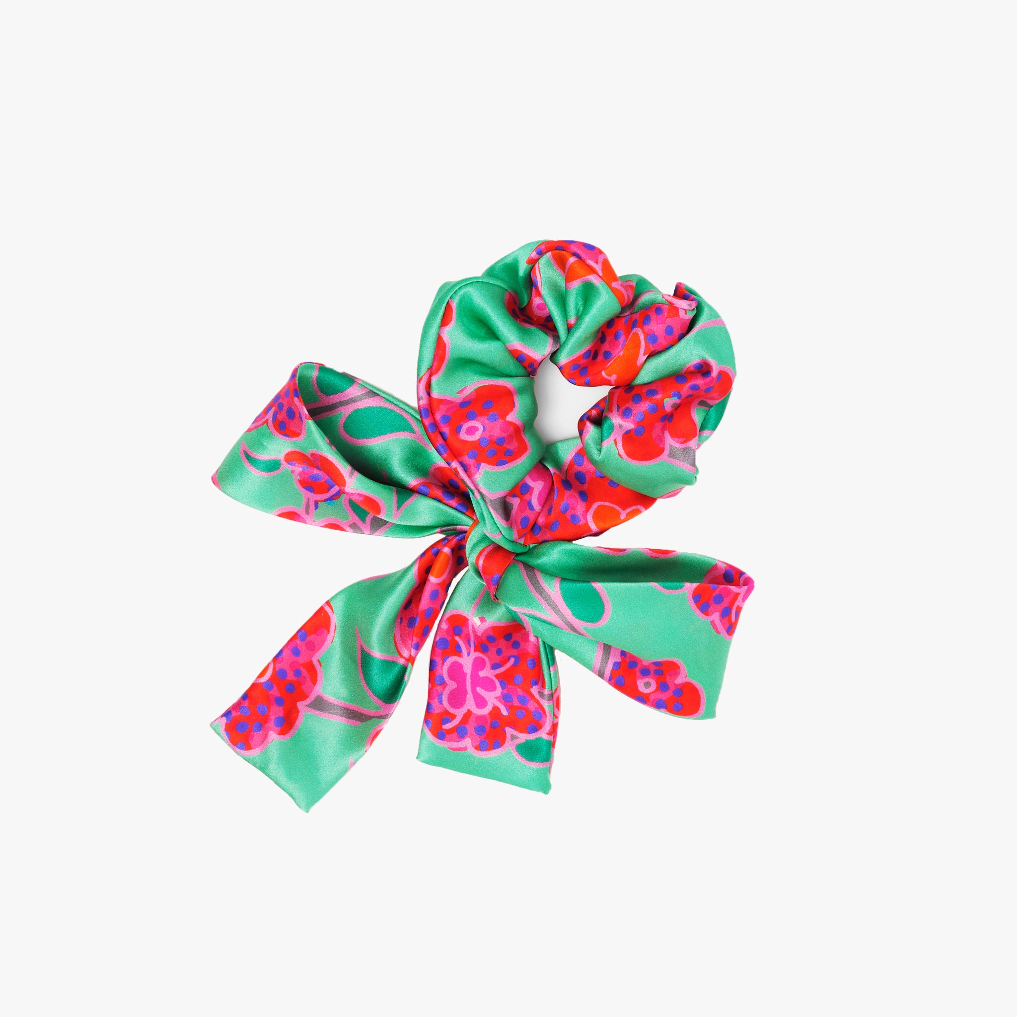 Srunchie with a bow featuring Crimson Rose hand drawn flower print from the Island Dreams collection in green, red, pink, orange and purple.