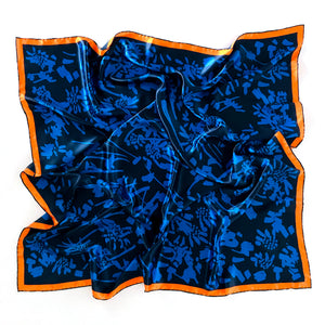 An explosion of daisies and gestural brush strokes ignite in this energetic Crimson Rose scarf design. The midnight blue base makes the scarf easy to style with a variety of looks. Whilst the vibrant orange border adds a pop of colour. Printed silk scarf with hand rolled hem.